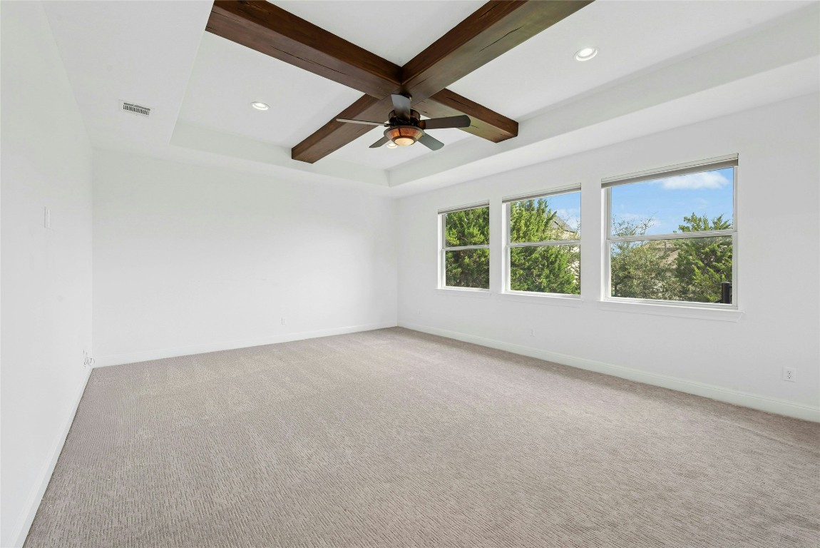 15729 De Fortuna Drive Bee Cave, TX 78738 - Photo 26 of 40 Empty room with coffered ceiling, beamed ceiling, light colored carpet, and recessed lighting