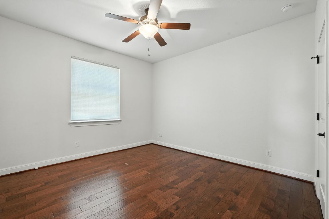 15729 De Fortuna Drive Bee Cave, TX 78738 - Photo 32 of 40 Unfurnished room with dark wood-type flooring and a ceiling fan