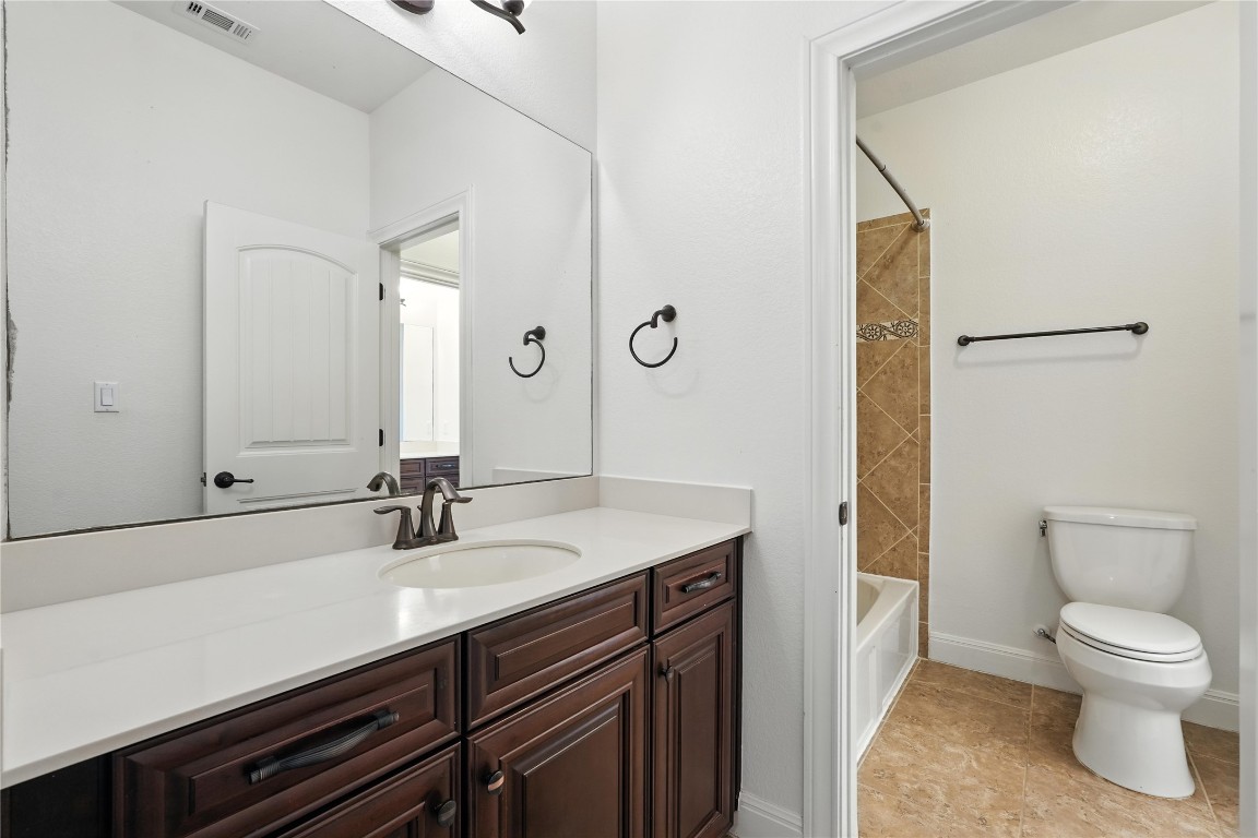 15729 De Fortuna Drive Bee Cave, TX 78738 - Photo 33 of 40 Bathroom with vanity, shower combination, and tile patterned flooring