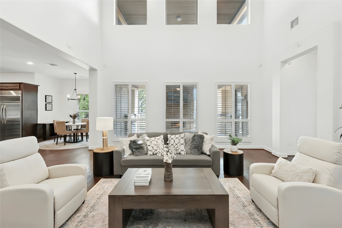 15729 De Fortuna Drive Bee Cave, TX 78738 - Photo 5 of 40 Living room with plenty of natural light, wood finished floors, and a high ceiling