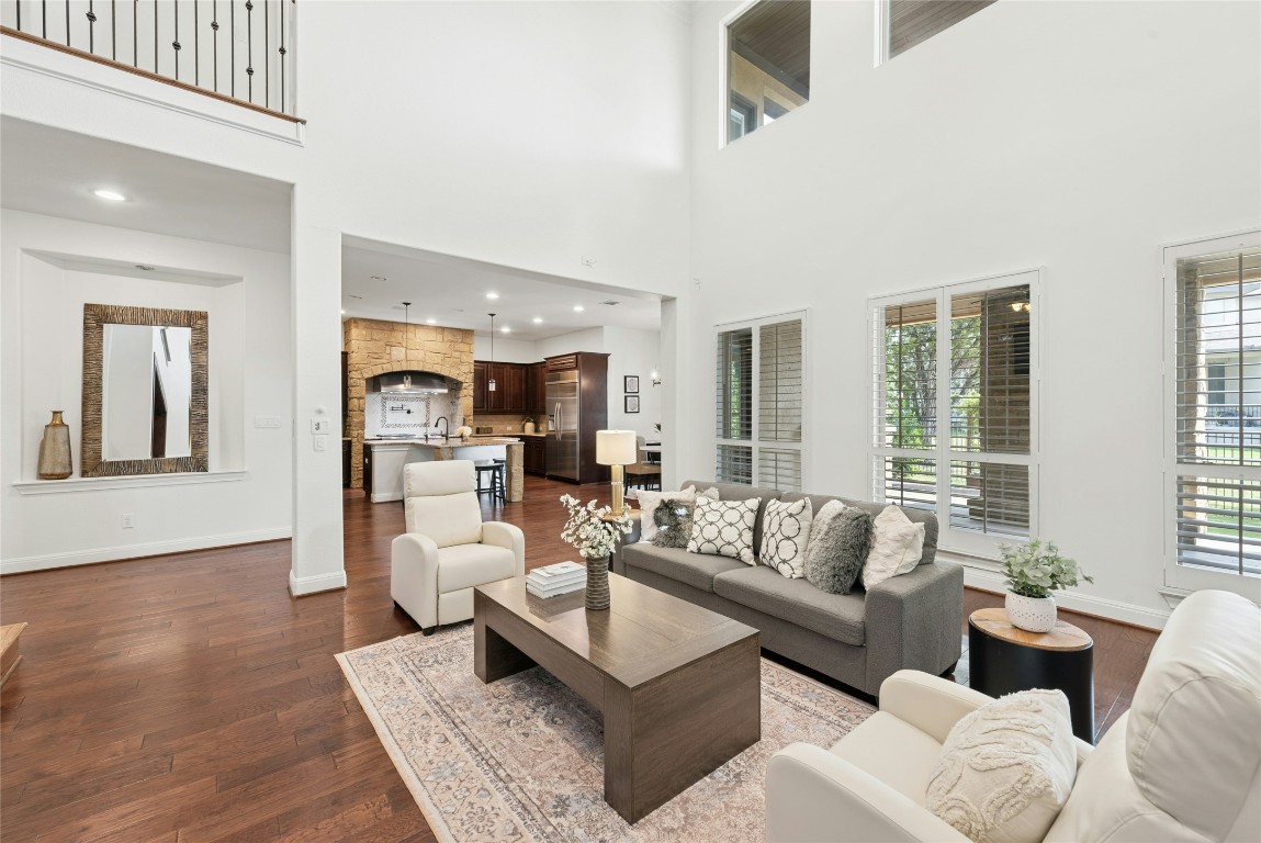 15729 De Fortuna Drive Bee Cave, TX 78738 - Photo 6 of 40 Living room featuring dark wood-style floors, a towering ceiling, and recessed lighting