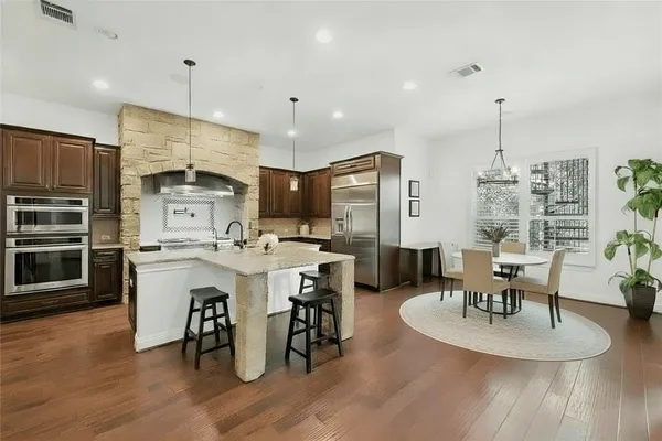 a kitchen with stainless steel appliances granite countertop a stove and a microwave
