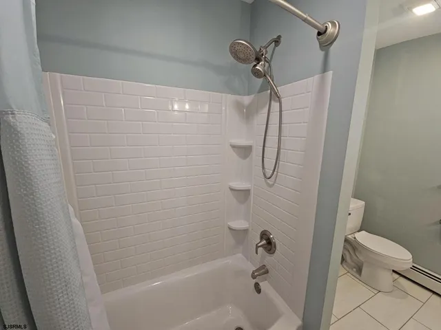a bathroom with a shower and a toilet