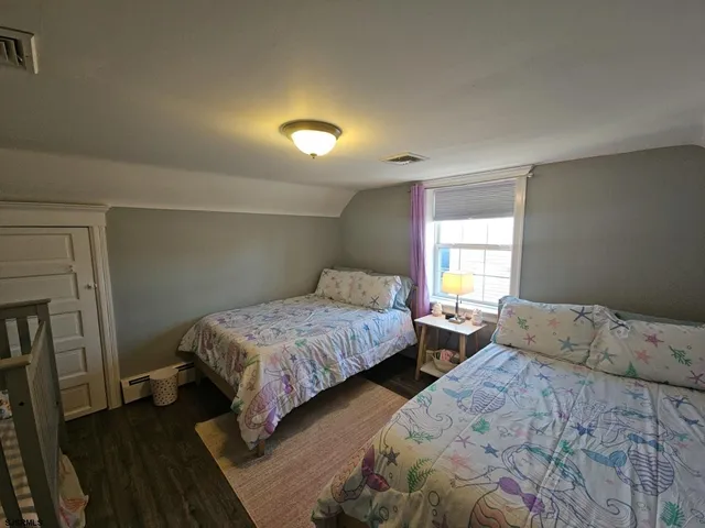 a bedroom with two beds and a window