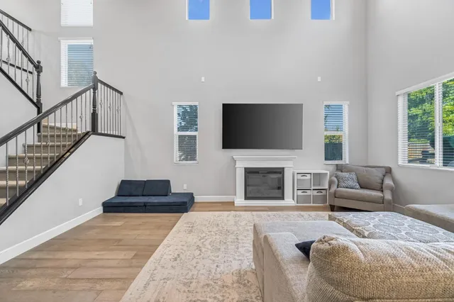 a living room with furniture a fireplace and a flat screen tv