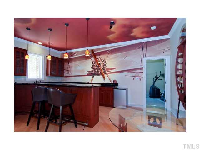 7000 Potomac Court Raleigh, NC 27613 - Photo 14 of 18 a kitchen with a sink a table and chairs