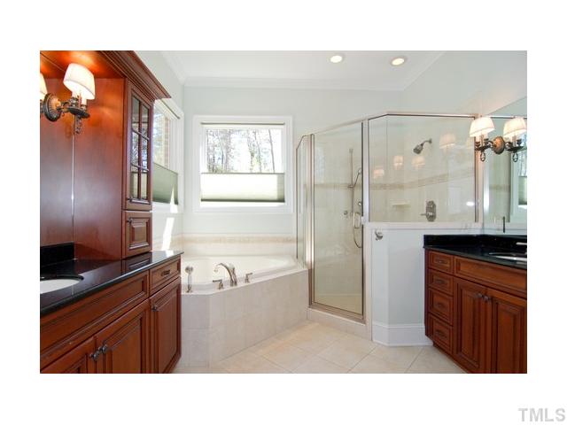 7000 Potomac Court Raleigh, NC 27613 - Photo 9 of 18 a bathroom with a sink a mirror and a shower