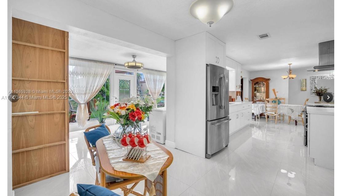 4941 Northwest 55th Court Tamarac, FL 33319 - Photo 13 of 30 a living room with furniture and a chandelier