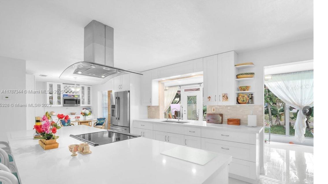 4941 Northwest 55th Court Tamarac, FL 33319 - Photo 15 of 30 a living room with furniture and a chandelier