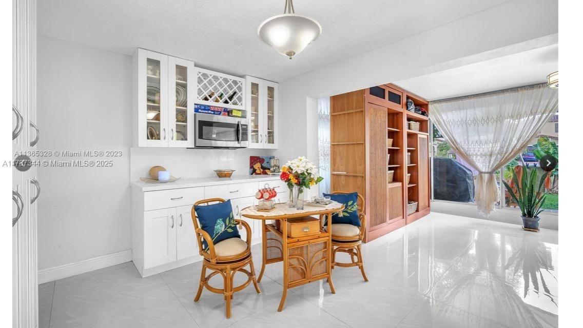 4941 Northwest 55th Court Tamarac, FL 33319 - Photo 16 of 30 a dining room with furniture and window