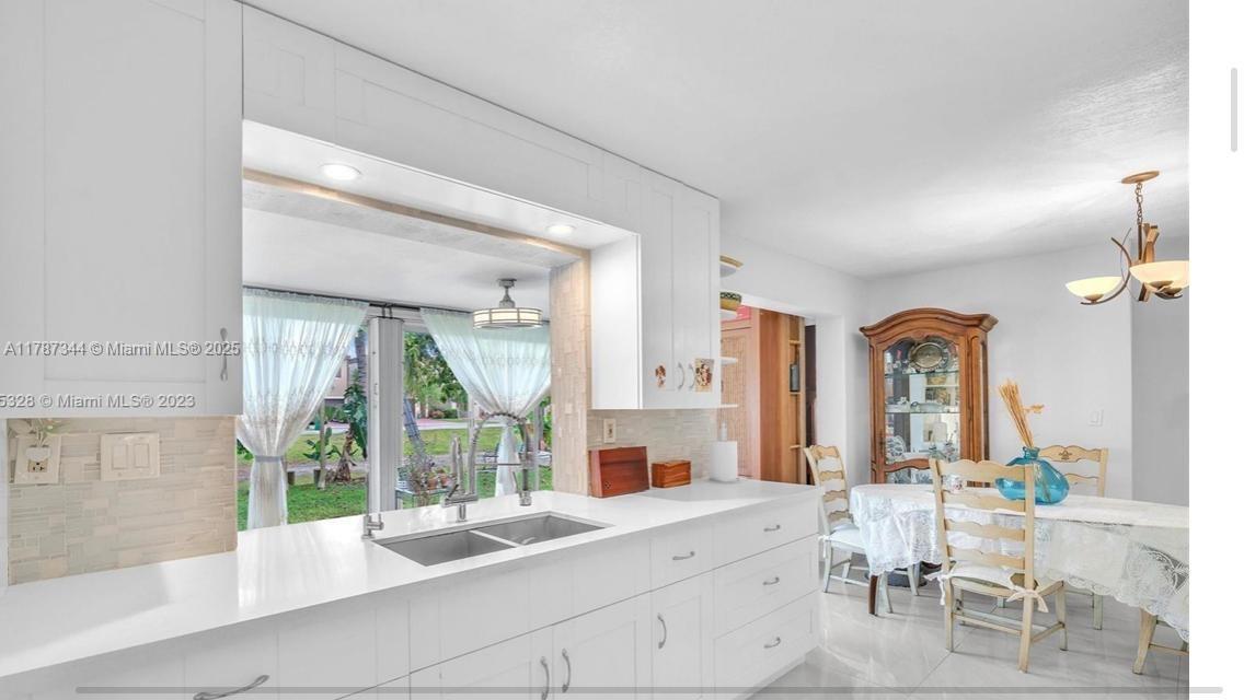 4941 Northwest 55th Court Tamarac, FL 33319 - Photo 23 of 30 a large white kitchen with a large window
