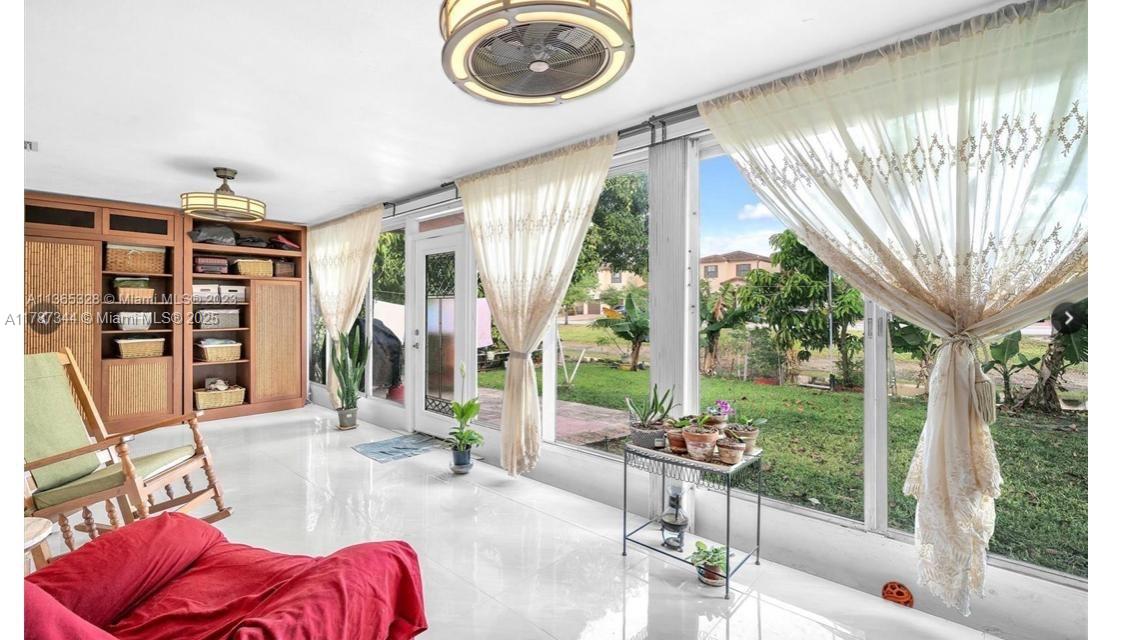 4941 Northwest 55th Court Tamarac, FL 33319 - Photo 26 of 30 a living room with furniture and a floor to ceiling window