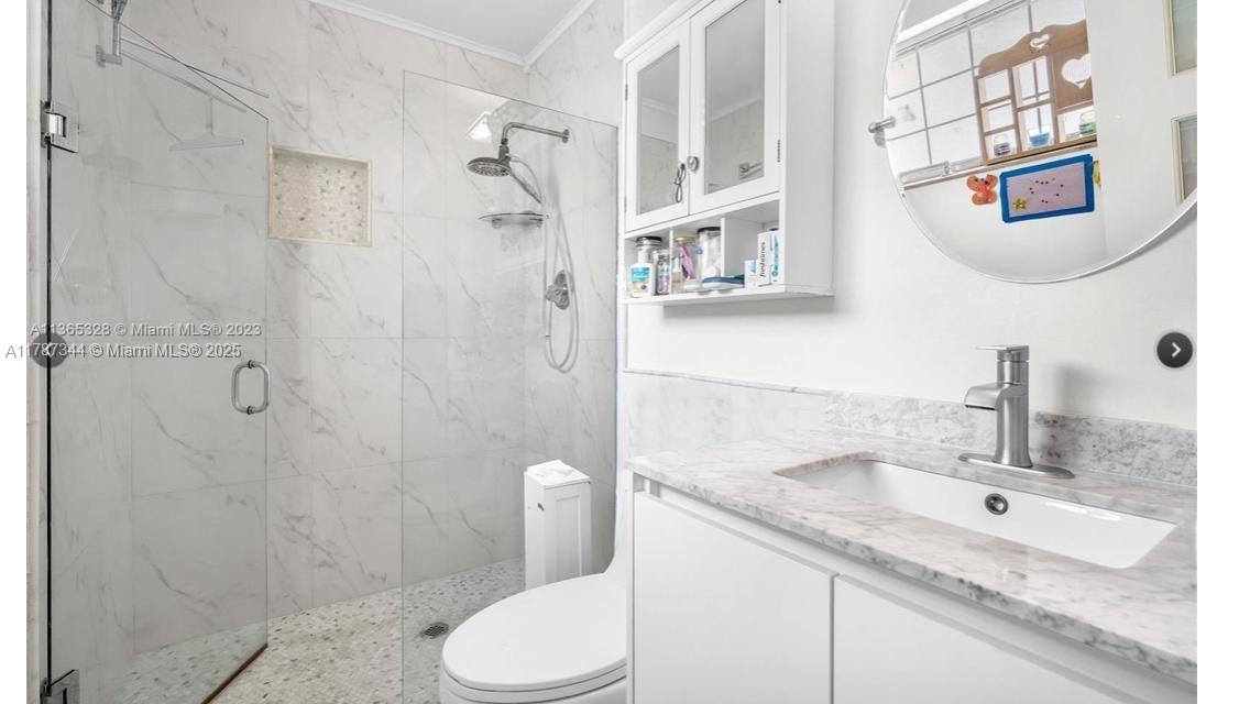 4941 Northwest 55th Court Tamarac, FL 33319 - Photo 27 of 30 a bathroom with a granite countertop sink toilet and shower