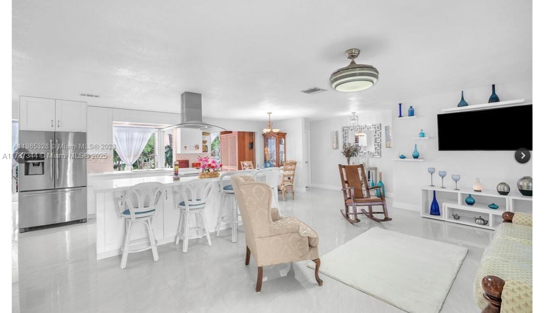 4941 Northwest 55th Court Tamarac, FL 33319 - Photo 7 of 30 a living room with furniture and a flat screen tv