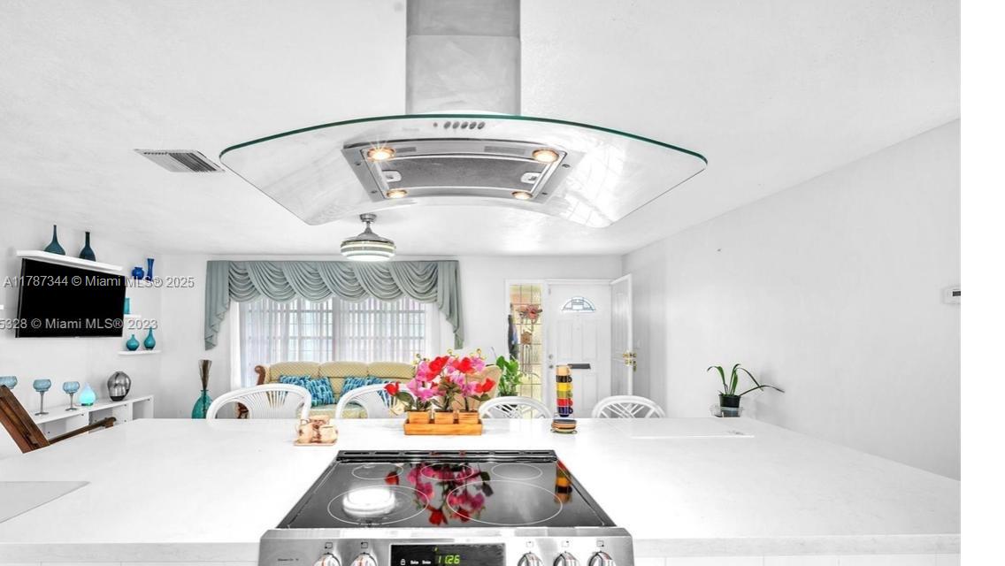 4941 Northwest 55th Court Tamarac, FL 33319 - Photo 9 of 30 a living room with furniture and a flat screen tv