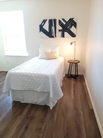 a bedroom with a bed and a night stand