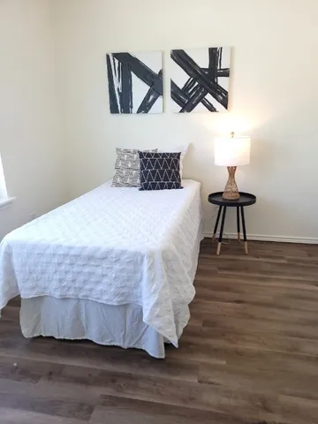 a large bed sitting in a bedroom next to a window