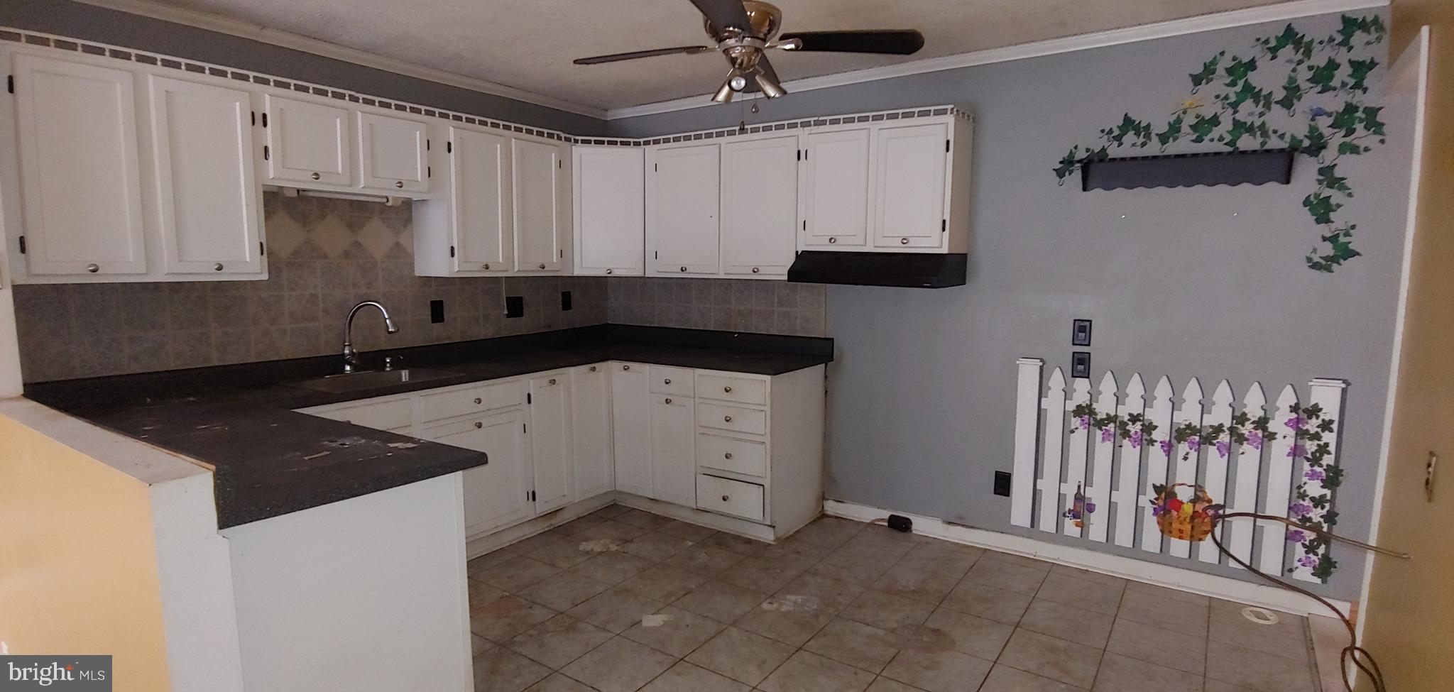 1305 2nd Road Baltimore, MD 21220 - Photo 5 of 6 a kitchen with granite countertop a sink a stove and cabinets