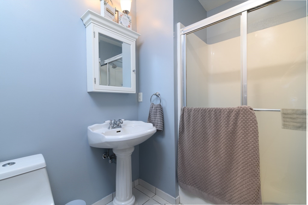501 Commerce Drive, Unit 2310 Braintree, MA 02184 - Photo 12 of 23 a bathroom with a sink mirror and toilet