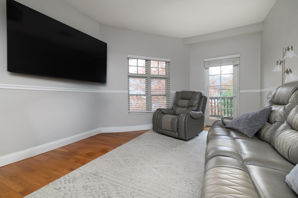 501 Commerce Drive, Unit 2310 Braintree, MA 02184 - Photo 5 of 23 a living room with furniture and a flat screen tv