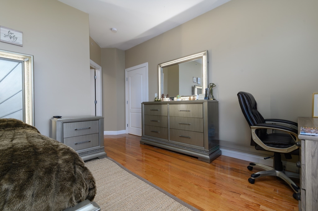 501 Commerce Drive, Unit 2310 Braintree, MA 02184 - Photo 7 of 23 a bedroom with a bed and cabinets