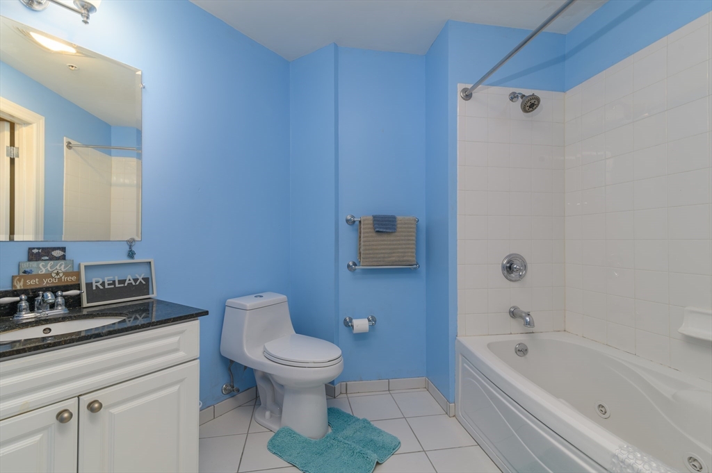 501 Commerce Drive, Unit 2310 Braintree, MA 02184 - Photo 9 of 23 a bathroom with a toilet a sink and bathtub