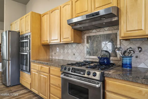 a kitchen with stainless steel appliances granite countertop a stove and a refrigerator