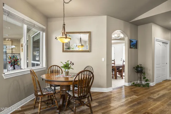 a view of a dining room with furniture window and wooden floor