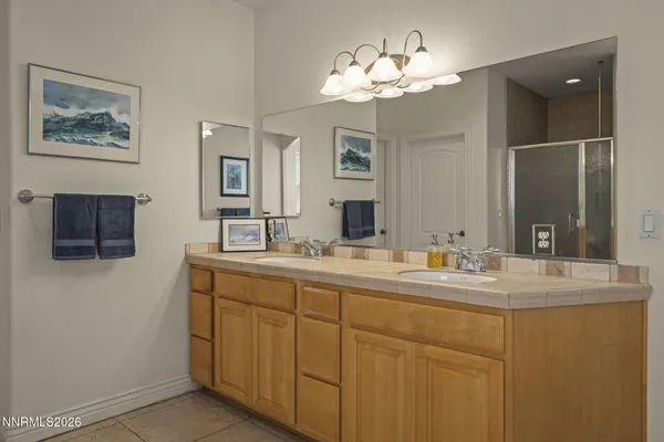 a bathroom with a double vanity sink and a mirror