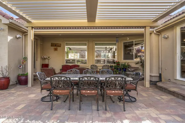 a view of a patio with table and chairs