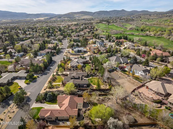an aerial view of a house with a yard