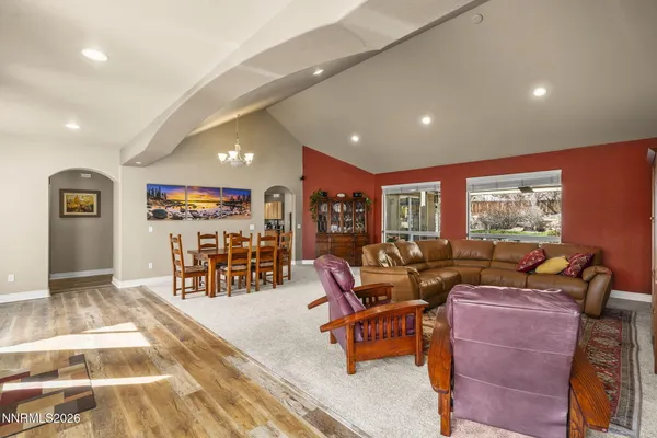 a living room with furniture a couch and large window