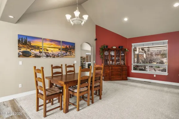 a view of a dining room with furniture and chandelier