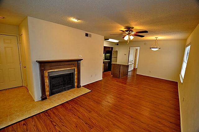 6910 Skillman Street, Unit 2016 Dallas, TX 75231 - Photo 6 of 23 a view of a livingroom with a fireplace and wooden floor