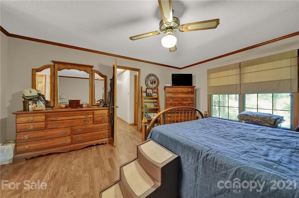 764 Pitts Road Catawba, SC 29704 - Photo 40 of 43 a bedroom with a bed and a chandelier