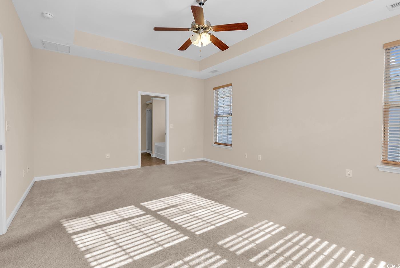 1612 Fairforest Court Conway, SC 29526 - Photo 21 of 40 Spare room with a tray ceiling, light colored carpet, and a ceiling fan