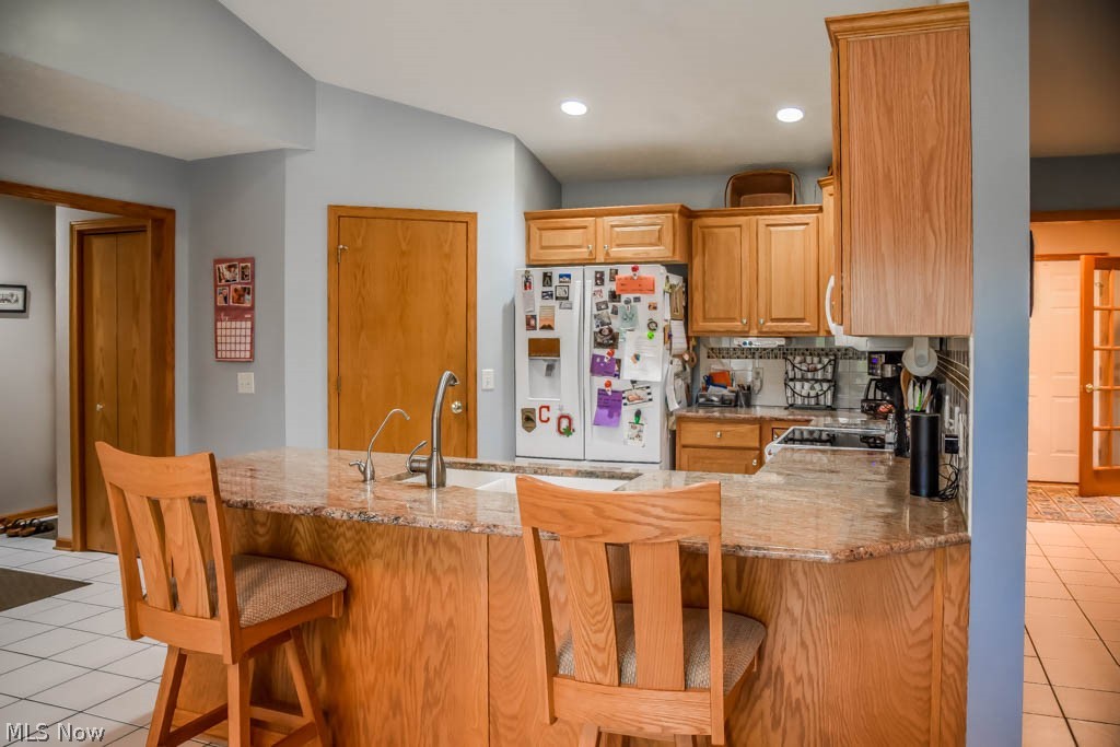 7004 Sweetwater Road Northeast Canton, OH 44721 - Photo 5 of 35 The kitchen has a breakfast bar and granite countertops.