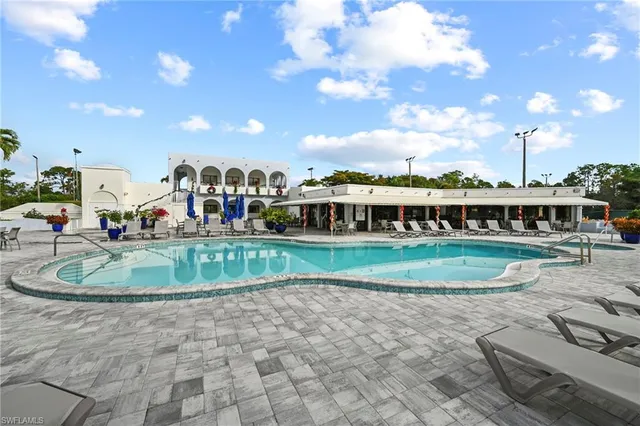 a swimming pool with outdoor seating and yard