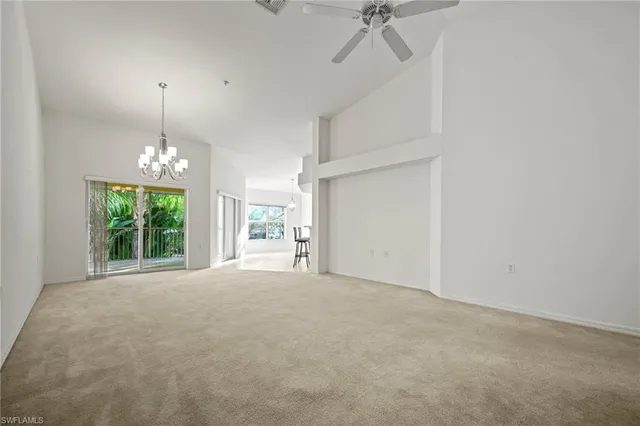 a view of a room with windows and ceiling fan