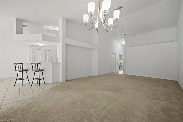 a view of a chandelier and a chandelier fan in a room