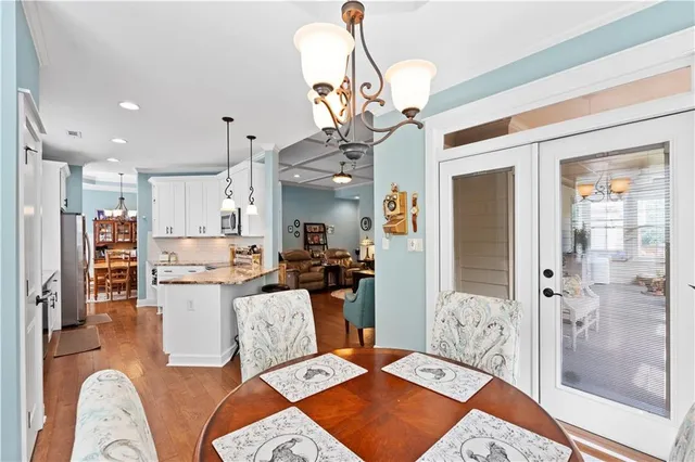a living room with stainless steel appliances kitchen island granite countertop furniture and a rug