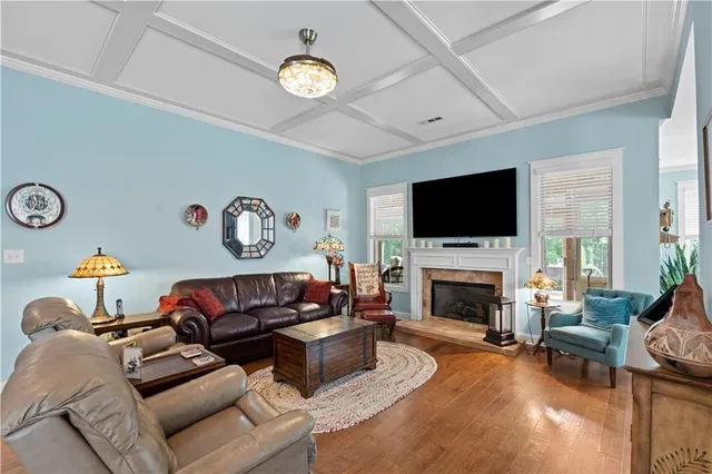 a living room with furniture a fireplace and a flat screen tv