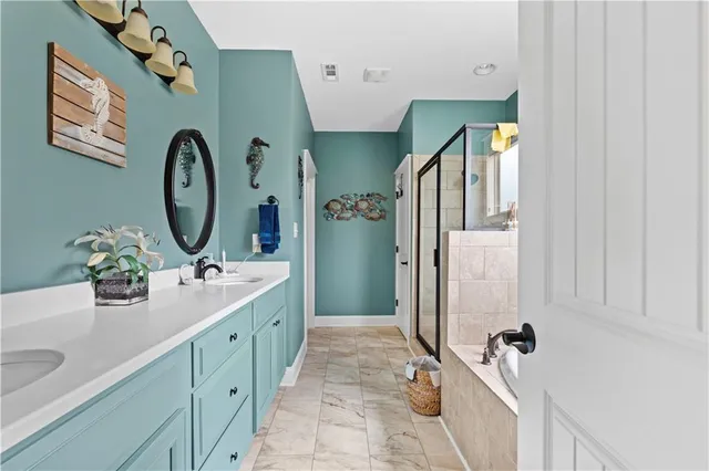 a bathroom with a double vanity sink mirror and toilet