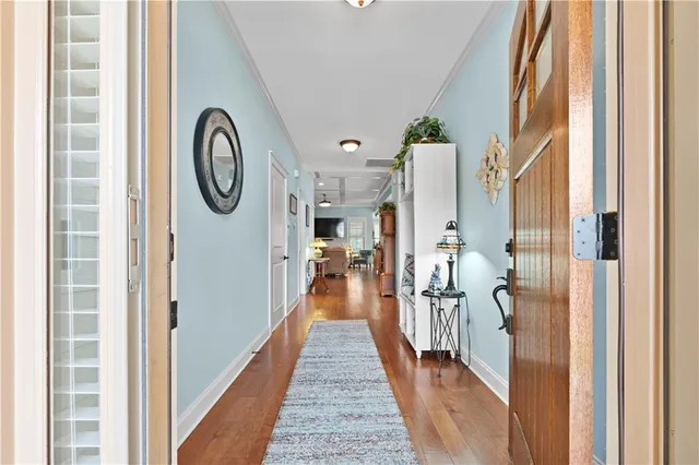 a view of a hallway with wooden floor and entryway