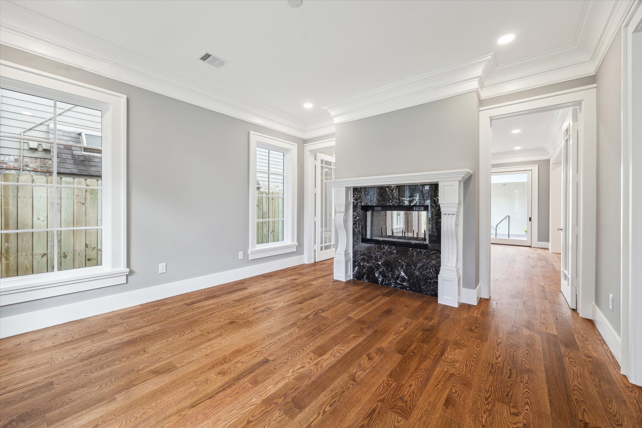 2216 Tangley Street Houston, TX 77005 - Photo 28 of 44 This light filled formal living room/study/music room features hardwood floors, high ceiling, beautiful crown molding and a stylish double-sided fireplace with a marble finish and flanked by doors that open to the den and can be closed for more privacy.