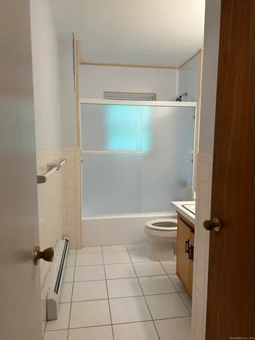 a bathroom with a shower and a toilet
