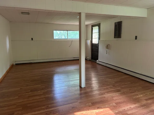 wooden floor in an empty room with a window