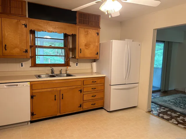 a kitchen with appliances a sink and a counter top space