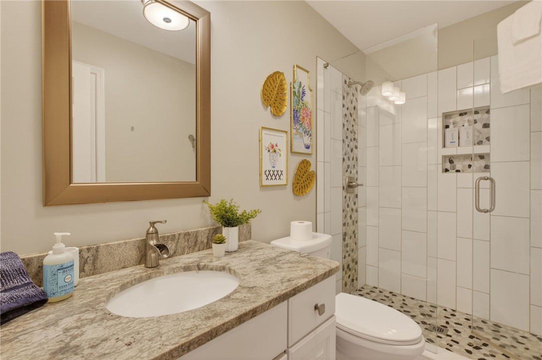 322 Shorecrest Drive Seneca, SC 29672 - Photo 4 of 30 This bathroom features a contemporary vanity with a granite countertop, a modern sink, and a spacious shower.