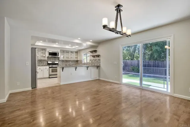a view of a kitchen with a sink and stainless steel appliances